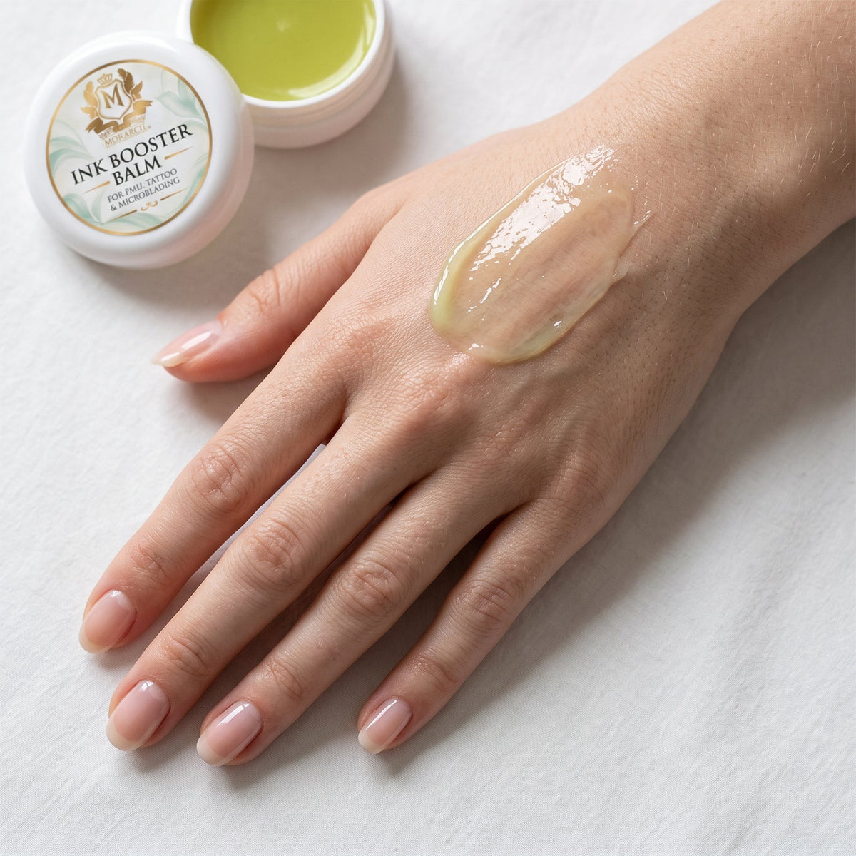 Glossy Skin Monarch Pigment Booster Formula balm spread on hand for photo finish